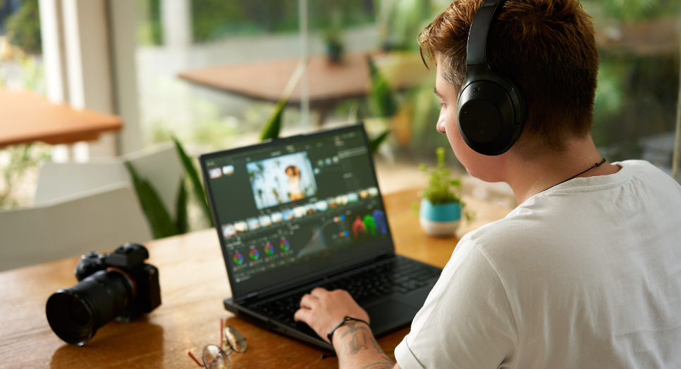 Man editing video on laptop 