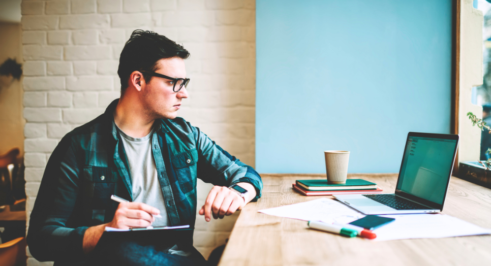 Man at computer trying to figure out how to license music for his digital business