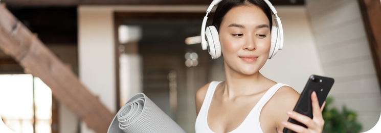 Woman choosing music in digital fitness app for her workout