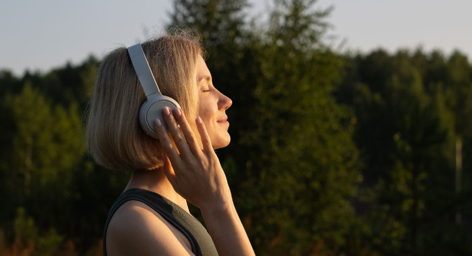 woman listening to music expressing emotion of wellbeing